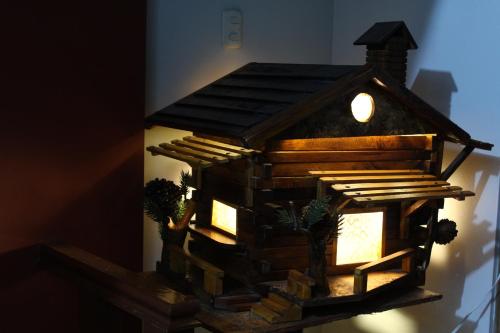 a model of a bird house on a wall at Kame House hostel in Huaraz