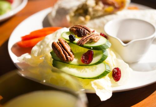 a plate with a sandwich with fruit and nuts on it at Mare Cielo in Xiaoliuqiu
