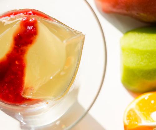 a glass bowl filled with sauce next to some fruit at Mare Cielo in Xiaoliuqiu
