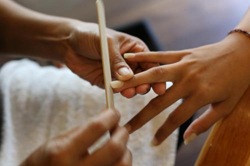 a group of hands holding a piece of wood at Aquarius Beach Hotel in Sanur