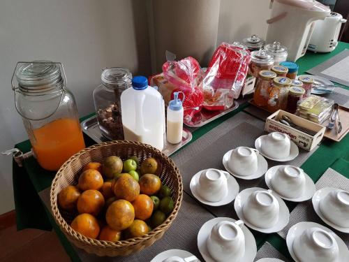 a table with a basket of fruit and bottles of milk at Arantarakiri Resort Khao Yai in Mu Si