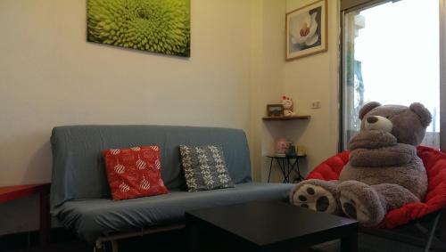 a teddy bear sitting on a couch in a living room at Jiufen B&B Uncle Xie's in Jiufen
