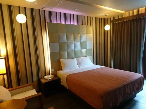 a hotel room with a bed and a lamp at 51 Spring in Wulai