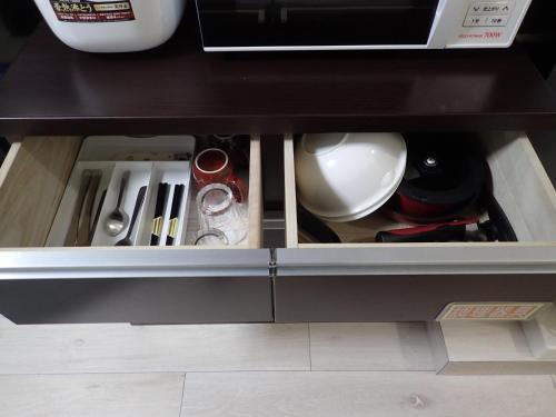 a drawer in a cabinet filled with utensils at Park Avenue Kokubunji in Koganei