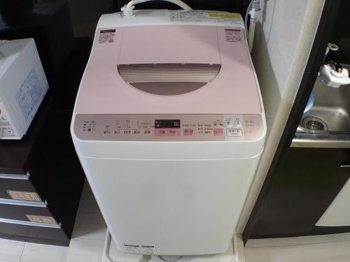 a white washing machine sitting on a shelf at Park Avenue Kokubunji in Koganei