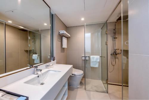 a bathroom with a sink and a toilet and a shower at Hotel Sirius in Jeju