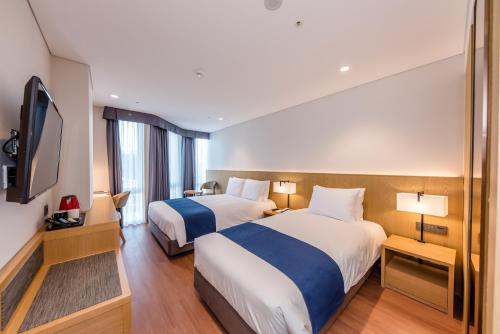 Postel nebo postele na pokoji v ubytování Hotel Sirius