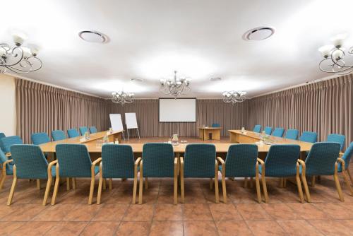 a conference room with a long table and chairs at Our Heritage Guesthouse in Kempton Park