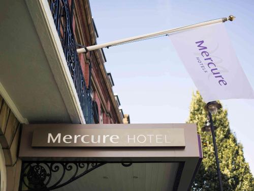 a sign for a mercure hotel with a flag at Mercure Doncaster Centre Danum Hotel in Doncaster