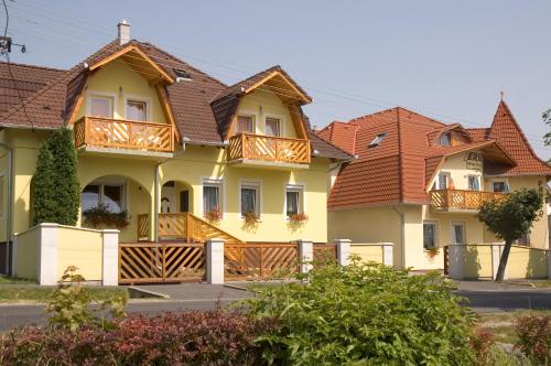 a row of houses with wooden balconies on them at Erika Pension in Keszthely