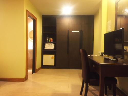 a room with a desk with a computer and a black door at Hua Hin White Sand in Hua Hin