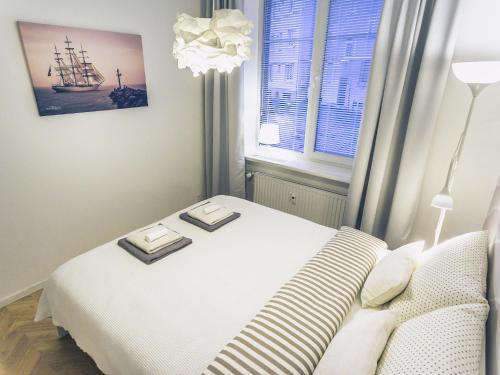 a bedroom with a bed with two plates on it at No.3 Apartment Link-To-Happiness in Klaipėda
