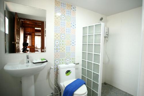 a bathroom with a toilet and a sink at Park & Pool Resort in Nong Khai