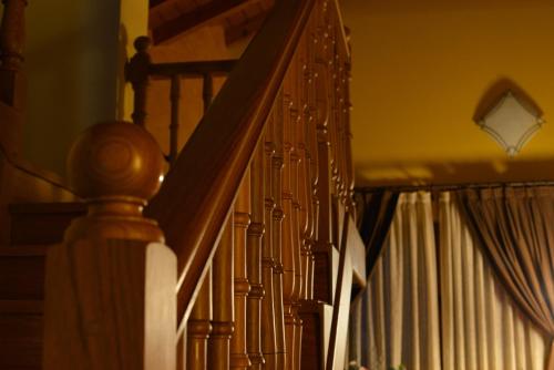 a set of stairs with a railing and a stair case at Alojamiento Bernabales in Pámanes