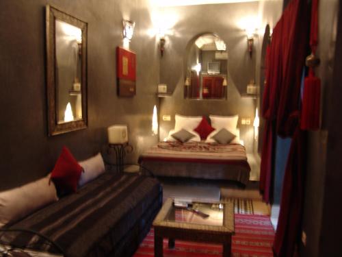 a living room with two beds and a couch at Riad Les Nuits de Marrakech in Marrakech
