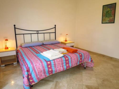 a bedroom with a bed with two tables and two lamps at Seaview Apartment (N° 21) in Porto Pozzo
