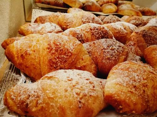 a bunch of pastries with powdered sugar on them at Wellness Hotel Gran Risa***S in La Villa