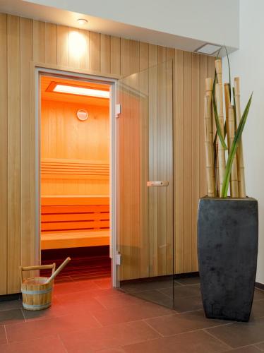 a door to a closet with a plant next to it at LÉGÈRE HOTEL Luxembourg in Luxembourg