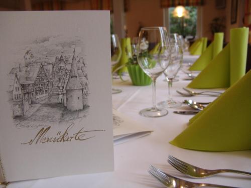 a table with a card with a drawing of a city on it at Gasthaus & Weingut zum Stern in Sulzfeld am Main