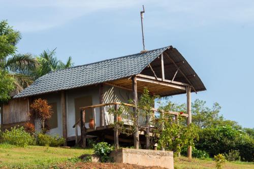 a small house with a gambrel roof at Living Waters Resort in Jinja
