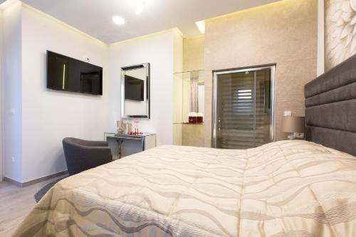 a bedroom with a large bed and a television at Villa Domina in Split