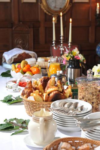 a table topped with food and plates of food at Chateau de Canisy in Canisy