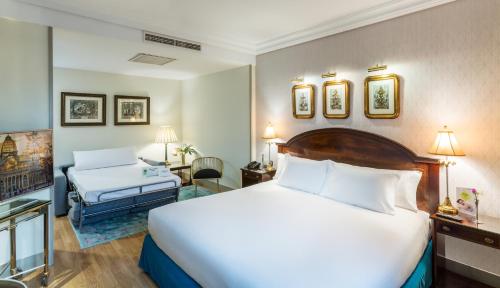Un pat sau paturi într-o cameră la Sercotel Gran Hotel Conde Duque