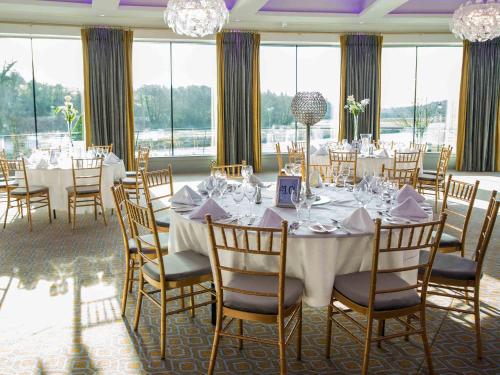 a dining room with a long table and chairs at The Riverside Park Hotel in Enniscorthy