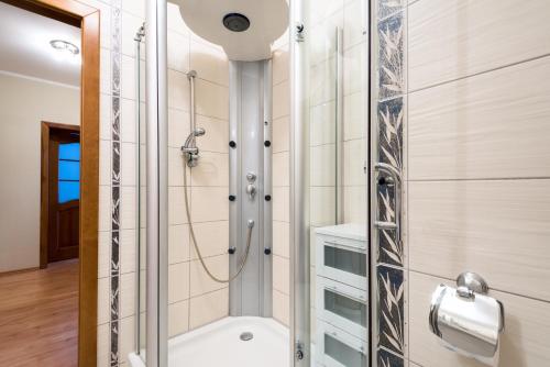 a bathroom with a shower and a toilet at Apartament Morski in Kołobrzeg