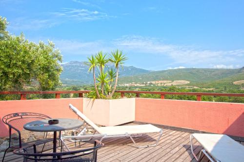 a patio with a table and chairs on a balcony at Hotel Macchia e Mare in Pietracorbara