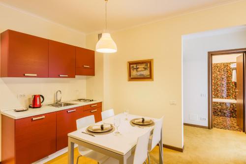a kitchen with a table and a white table and chairs at Hotel Boutique Belvedere in Sinaia