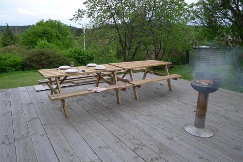 a wooden picnic table sitting on a wooden deck at Beautiful and Spacious Contemporary house in Oignies-en-Thierache