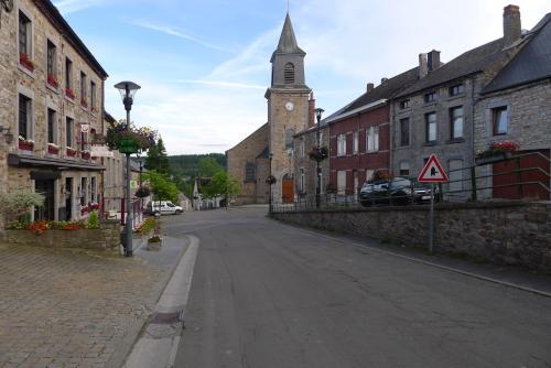an empty street in a town with a clock tower at Beautiful and Spacious Contemporary house in Oignies-en-Thierache