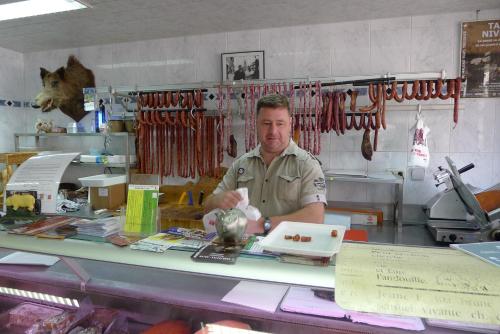 a man is standing behind a counter in a shop at Beautiful and Spacious Contemporary house in Oignies-en-Thierache