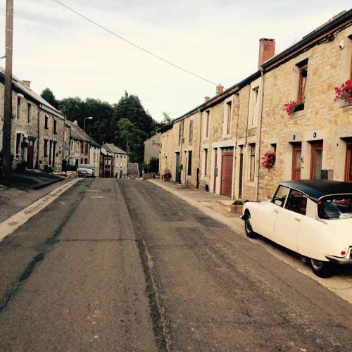 an old white car parked on the side of a street at Beautiful and Spacious Contemporary house in Oignies-en-Thierache