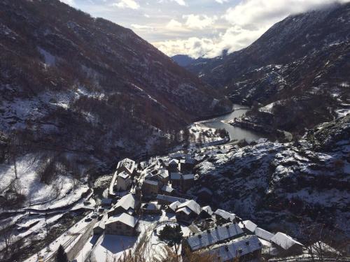 an aerial view of a village in a snowy mountain at Hotel Estanys Blaus in Tavascan