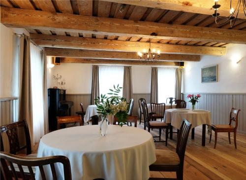 a dining room with two tables and chairs at Meke in Mustkalni