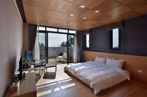 a bedroom with a large bed and a television in it at Shan Yi Fang Resort in Yuanshan