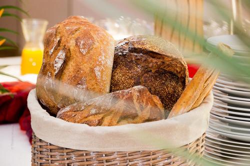 a basket filled with bread sitting on top of a table at Akoya Hotel & Spa in Saint-Gilles les Bains