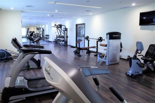 a gym with treadmills and cardio equipment in a room at Best Western Plus Salmiya in Kuwait