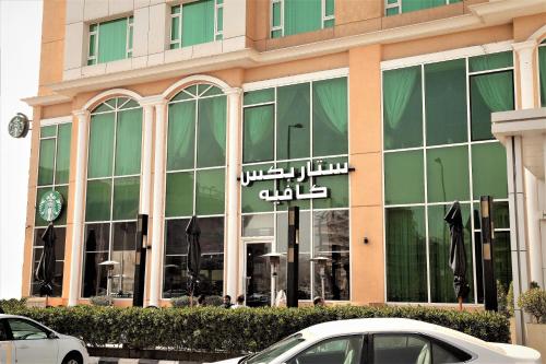 a large building with a clock in the window at Best Western Plus Salmiya in Kuwait