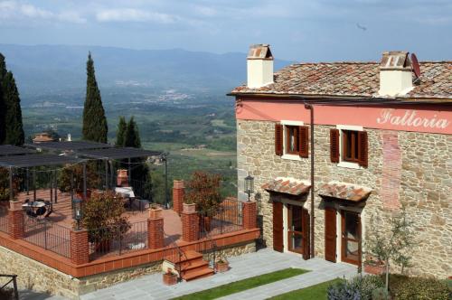 a house with a balcony with a view at Agriturismo La Forra in Cavriglia