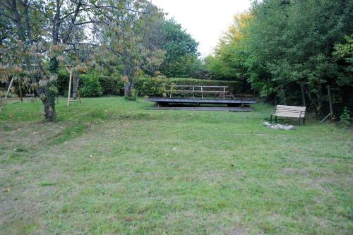 a park with a bench and a picnic table in a field at Beautiful and Spacious Contemporary house in Oignies-en-Thierache