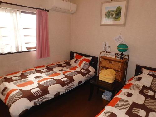 Postel nebo postele na pokoji v ubytování Kyoto Inn Higashiyama