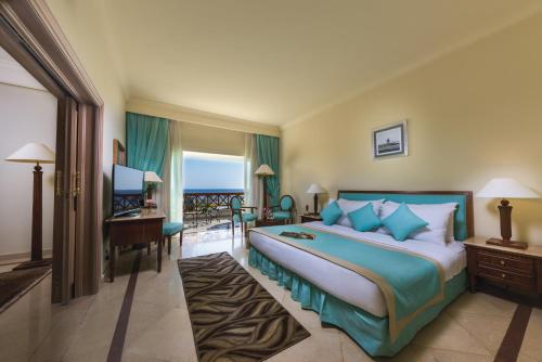 a hotel room with a bed and a television at Movenpick Taba Resort & Spa in Taba