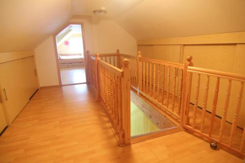 a wooden staircase in a room with a wooden floor at Hotel Restaurant Svejk in Bublava
