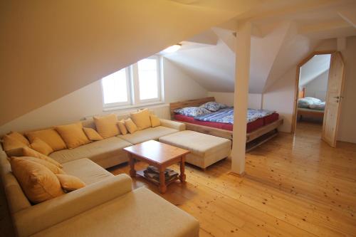 a living room with a couch and a bed at Hotel Restaurant Svejk in Bublava