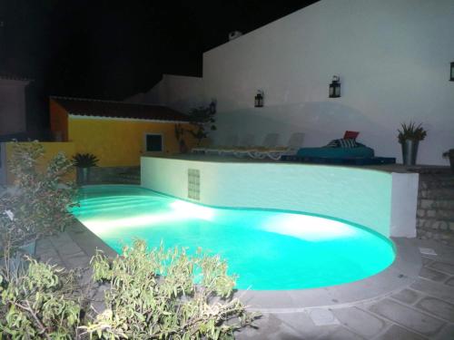 a swimming pool in a backyard at night at Villa Terra Da Eira in Mafra