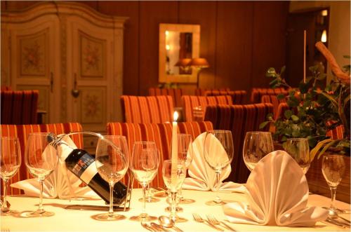 a table with glasses and a bottle of wine on it at Hotel Central in Willingen