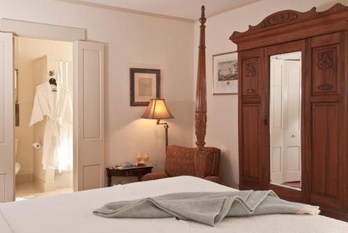 a bedroom with a bed and a dress hanging in a closet at Marshall Slocum Inn in Newport